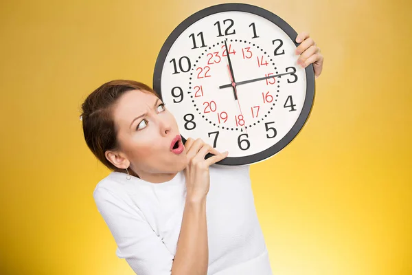 Stressed woman holding clock looking anxiously running out of time — Stock Photo, Image