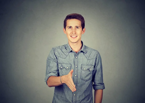 Casual young man offering handshake — Stock Photo, Image