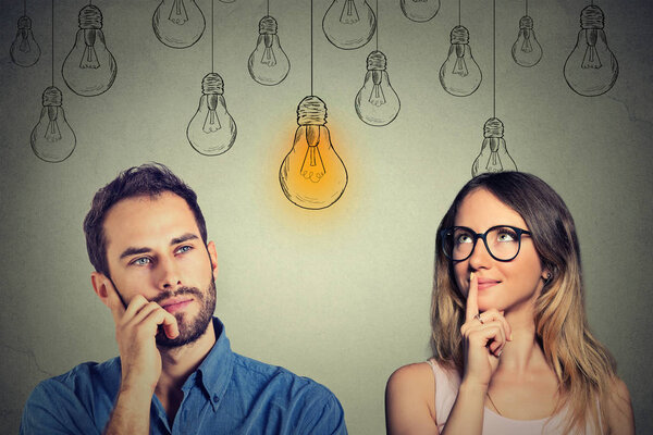 Cognitive skills male vs female. Man and woman looking at light bulb 