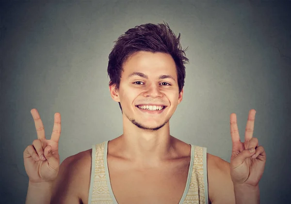 Young man, handsome student holding up peace victory, two sign — Stock Photo, Image