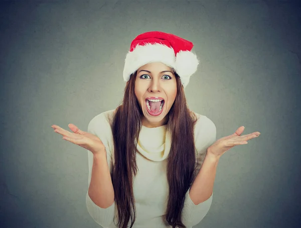 Surprised excited happy woman wearing red santa claus hat looking shocked — Stock Photo, Image