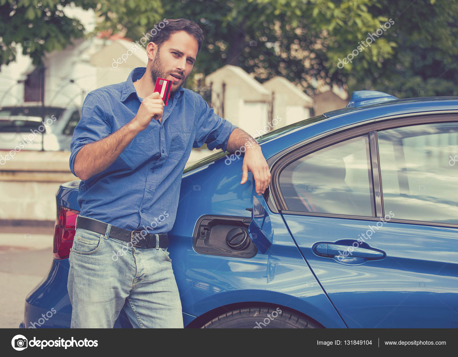 Handsome Man With Credit Card Opening Fuel Tank Of New Car Stock