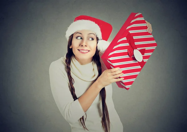 Excited woman wearing santa claus hat opening gift box — Stock Photo, Image