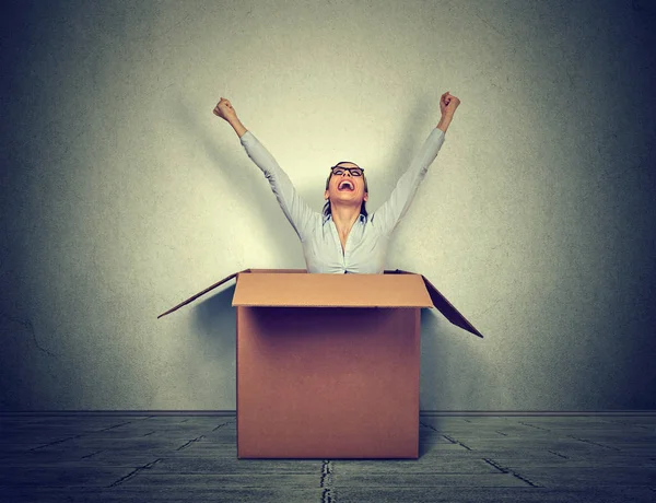 Feliz joven mujer saliendo de una pequeña caja — Foto de Stock