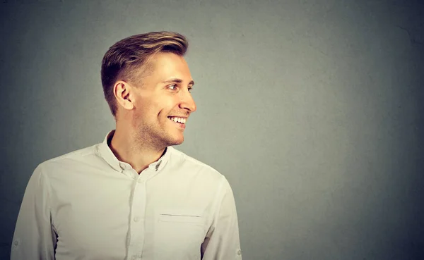 Side profile young man looking at his side smiling — Stock Photo, Image