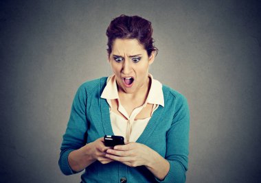 Shocked anxious scared girl looking at phone seeing bad news photos  clipart