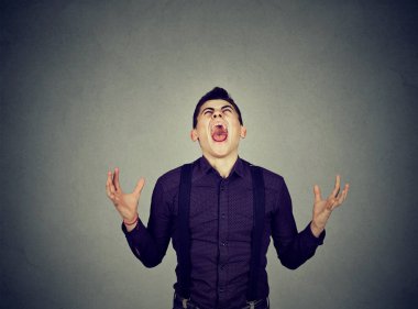 Frustrated desperate young man screaming  clipart