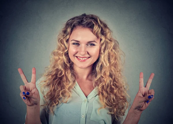 Happy teenage girl showing victory or peace sign — Stock Photo, Image