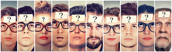 Multiethnic group of thinking people with question mark looking up — Stock Photo, Image