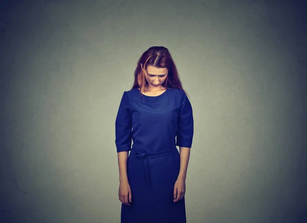Sad shy insecure young woman standing looking down — Stock Photo, Image