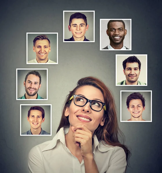 Happy woman thinking which man she likes loves the most — Stock Photo, Image
