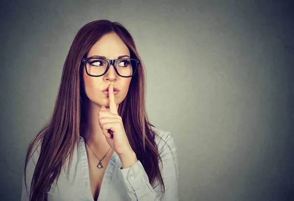 Woman saying hush be quiet with finger on lips gesture — Stock Photo, Image