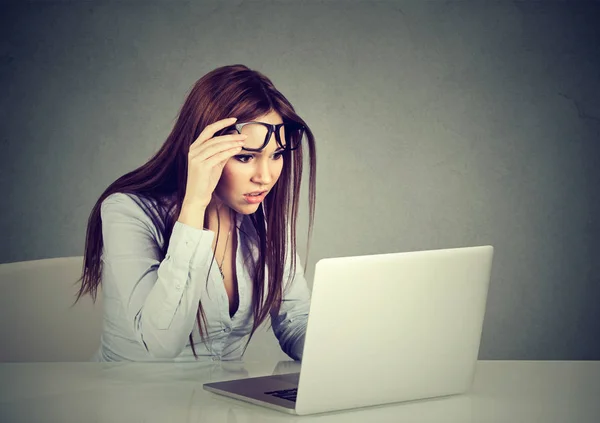 Vrouw met glazen problemen gezichtsvermogen verward met laptop — Stockfoto