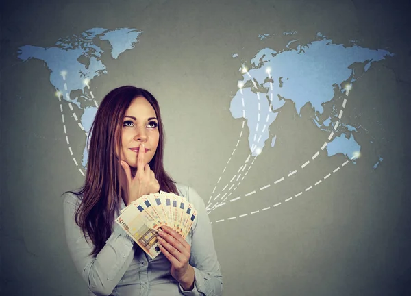 Thinking woman with euro cash deciding on next travel destination — Stock Photo, Image