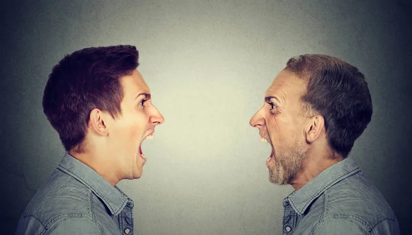 Angry young man screaming at old himself — Stock Photo, Image