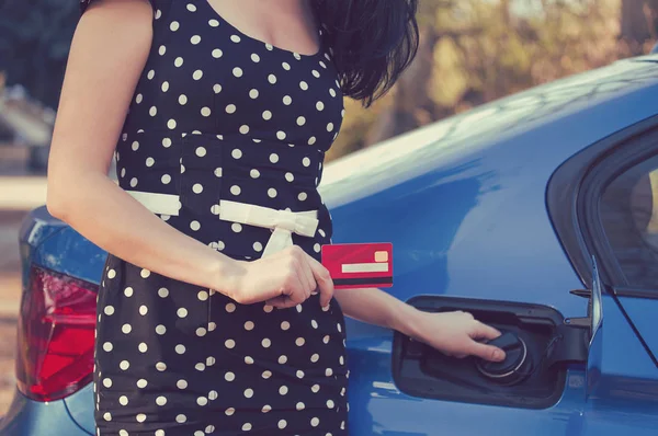 Closeup of a woman with credit card opening fuel tank of a car — Stock Photo, Image