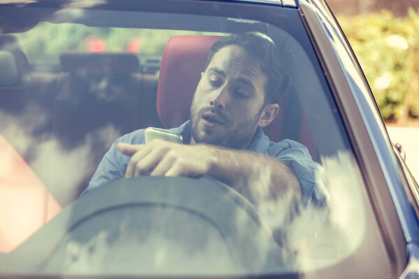 Man using cell phone texting while driving. Reckless driver concept 