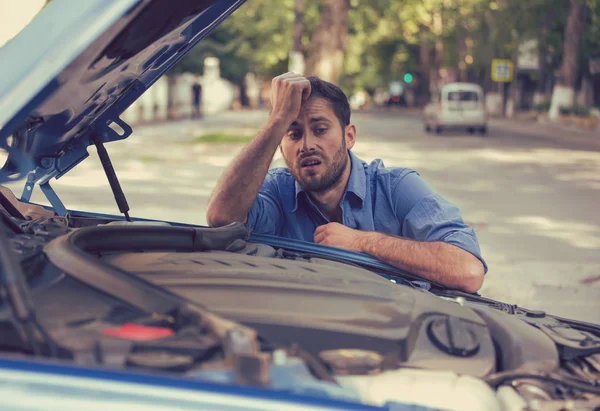 Benadrukt man problemen met gebroken auto op zoek in frustratie bij defecte motor — Stockfoto