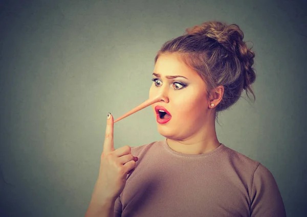 Shocked liar woman with long nose — Stock Photo, Image