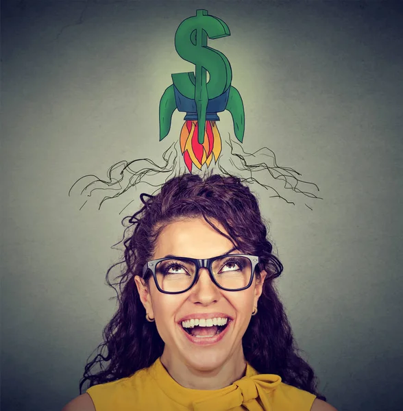 Woman looking up at dollar sign — Stock Photo, Image