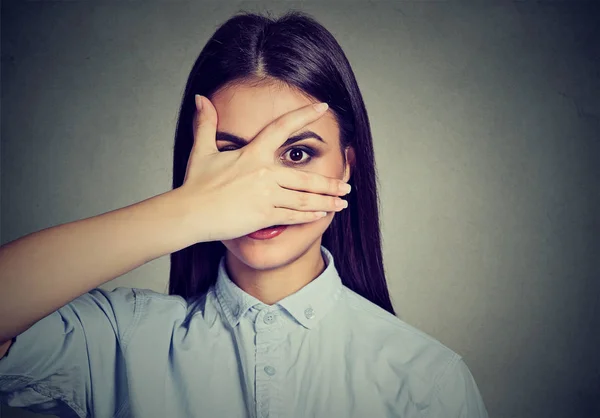 Happy woman peeping at you through fingers — Stock Photo, Image