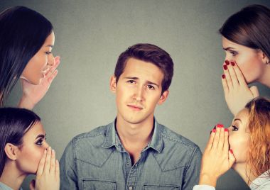 women whispering a secret latest gossip to a bored annoyed man  clipart