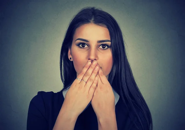 Brunette woman covers her mouth with hands — Stock Photo, Image