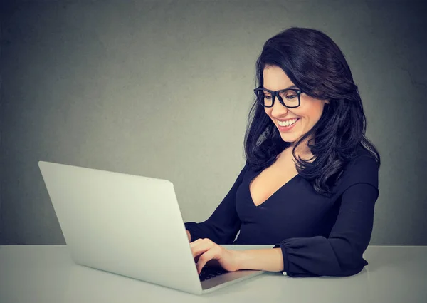 Улыбающаяся женщина, работающая с ноутбуком — стоковое фото