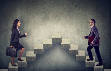 Young business woman and man stepping up a stairway career ladder  clipart