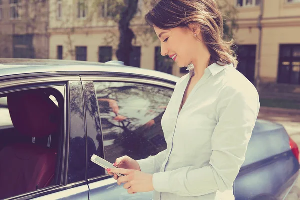 Durum, kontrol etmek için akıllı telefon kullanan kadın yeni arabasını kontrol — Stok fotoğraf