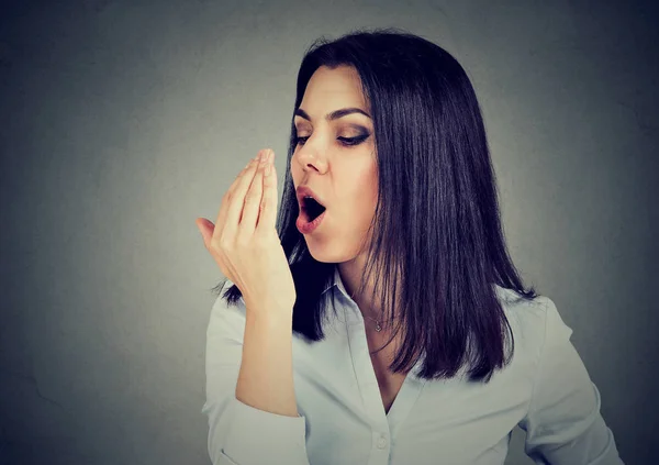 Woman checking her breath with hand. — Stock Photo, Image