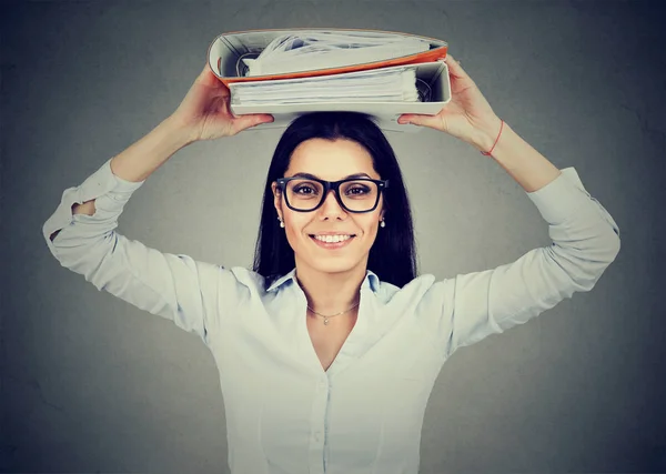 Happy businesswoman with office binders standing grinning at the camera — Stock Photo, Image