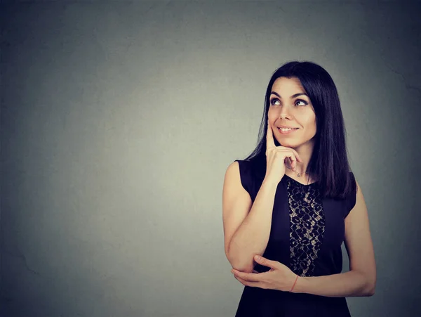 Portrait of a young woman smiling and thinking — Stock Photo, Image