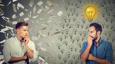 two serious businessmen looking at each other one under money rain another with bright ideas  clipart