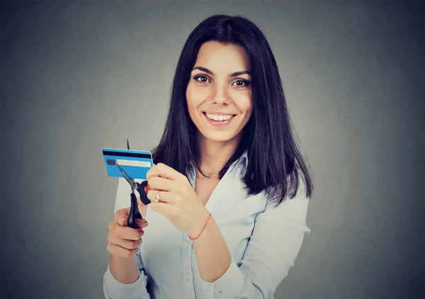 Happy woman cutting in half her credit card with scissors — Stock Photo, Image