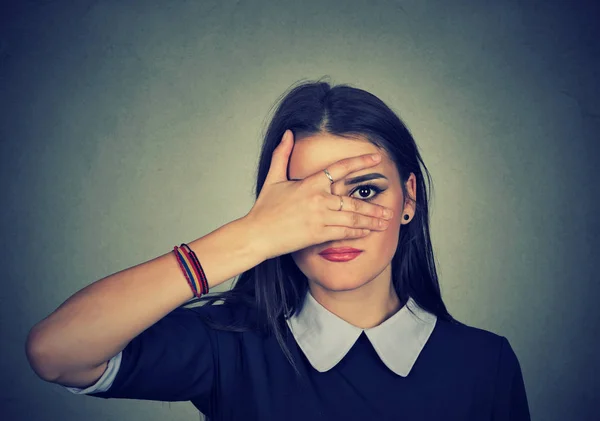 Woman peeking through the fingers — Stock Photo, Image