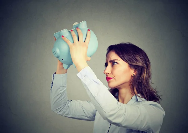 Worried woman with empty piggy bank — Stock Photo, Image