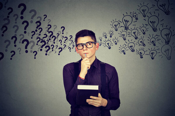 Young man finding answers to many questions generating ideas