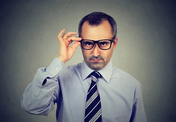 Skeptical mature business man looking at camera — Stock Photo, Image