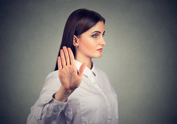 angry woman giving talk to hand gesture with palm outward 