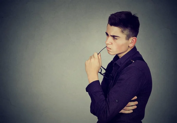 Portrait of suspicious doubtful young man — Stock Photo, Image