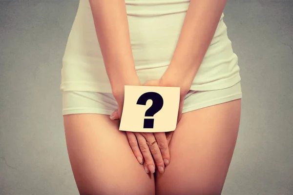 Woman holding paper with question mark over her crotch. Health hygiene sexual education concept — Stock Photo, Image