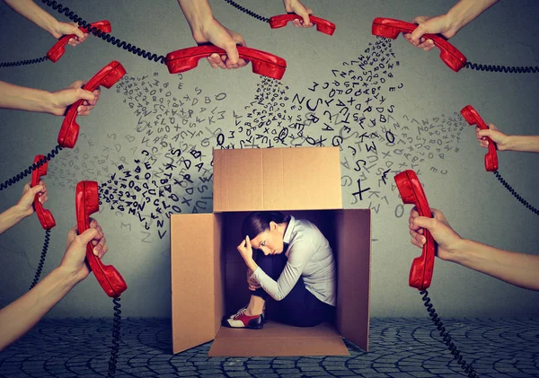 Stressed business woman hiding in a box overwhelmed by many telephone calls and errands should. Busy day of an employee — Stock Photo, Image