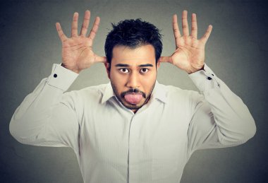 Man sticking out his tongue mocking someone clipart
