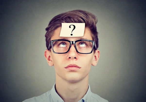 Thinking man with question mark looking up — Stock Photo, Image