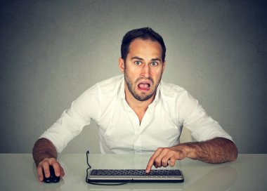 Confused upset man working on computer  clipart