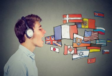 Young man in headphones learning different languages