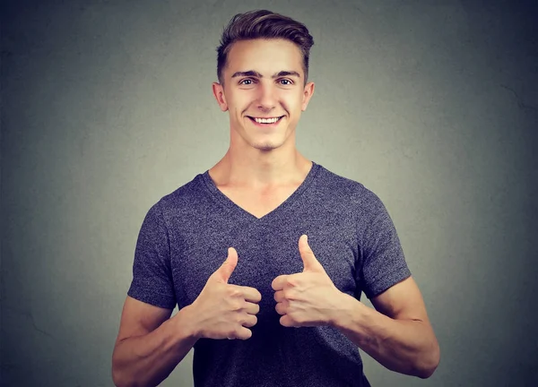 Jovem bonito feliz mostrando polegares para cima — Fotografia de Stock