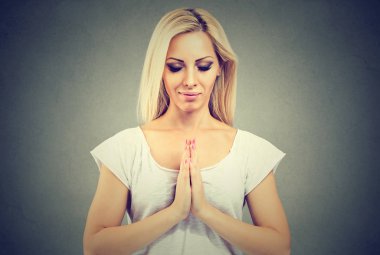 Young woman in a  prayer position meditating  clipart