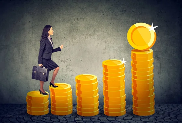 Business woman with briefcase stepping up a financial stairway ladder made of gold coins — Stock Photo, Image